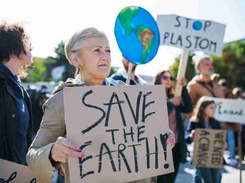 Senior with Save the Earth Sign